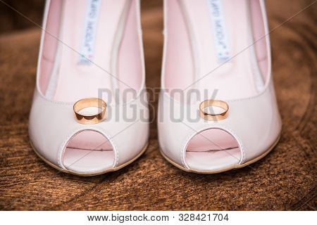 Rings Lie In The Shoes Of The Bride Close-up Shot