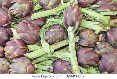 Background Of Many Ripe Fresh Green Artichokes At Market