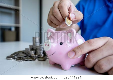 Man Putting Coins To Planning Growing Saving To Strategy With Piggy Bank For Future Plan Fund Of Tra