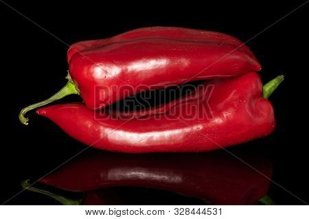 Group Of Two Whole Sweet Red Bell Pepper Isolated On Black Glass