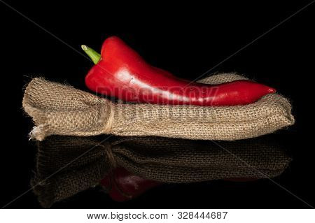 One Whole Sweet Red Bell Pepper With Jute Bag Isolated On Black Glass