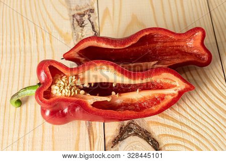 Group Of Two Halves Of Sweet Red Bell Pepper On Natural Wood