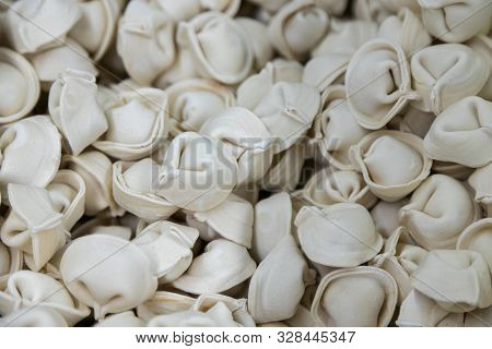 Uncooked Ready To Boil Or Fry Ravioli Or Pelemene In Pile. Bunch Of Pelemene Background, Flatlay At 