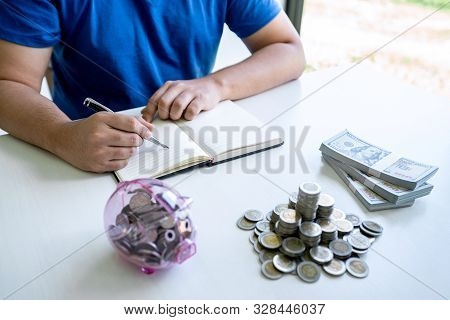 Man Putting Coins To Planning Growing Saving To Strategy With Piggy Bank For Future Plan Fund Of Tra