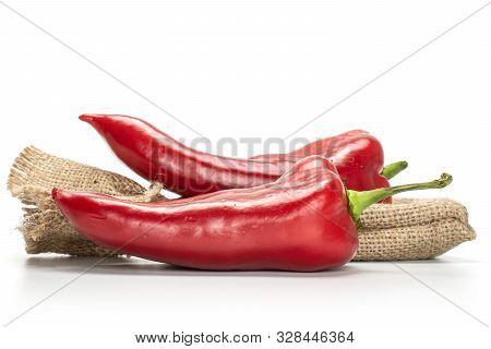 Group Of Two Whole Sweet Red Bell Pepper With Jute Bag Isolated On White Background