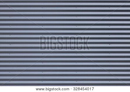 Close-up Of Grey Metal Ribbed Wall In Daylight