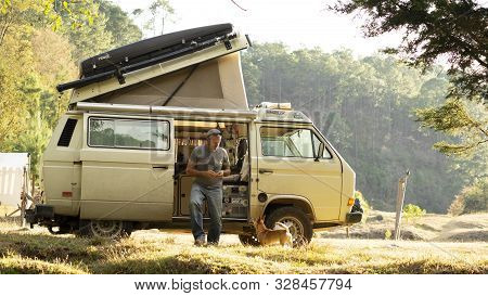 Encuentro Park, Chiapas, Mexico - Mar 23rd , 2018: Man Playing With Dog And A Camper Van
