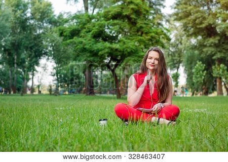 Portrait Of Young Smiling Business Woman In Red Suit In Earphones Listening To Music, Doing Online L