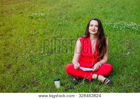 Portrait Of Young Smiling Business Woman In Red Suit In Earphones Listening To Music, Doing Online L