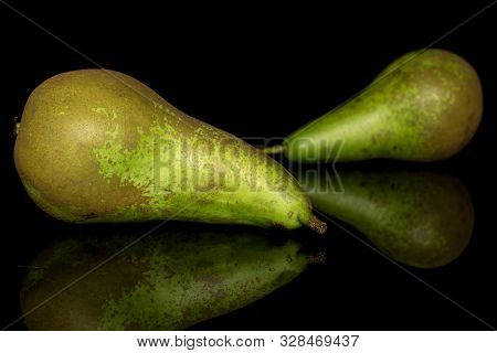 Group Of Two Whole Fresh Green Pear Isolated On Black Glass