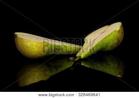 Group Of Two Halves Of Fresh Green Pear Isolated On Black Glass