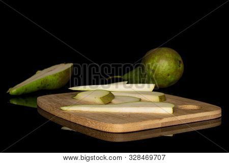 Group Of One Whole One Half Five Slices Of Fresh Green Pear On Bamboo Cutting Board Isolated On Blac
