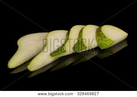 Group Of Five Slices Of Fresh Green Pear Isolated On Black Glass