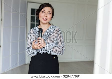 Asian Woman Talks Into Microphone Sings Nice