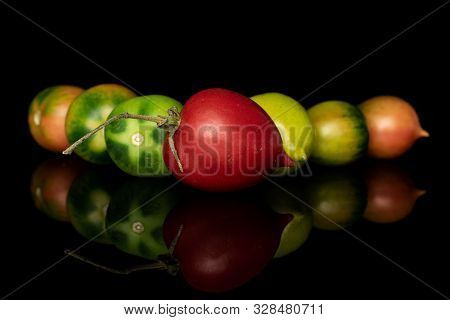Group Of Seven Whole Fresh Tomato De Barao Triangle Isolated On Black Glass