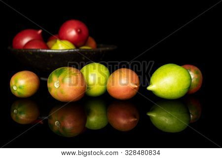 Lot Of Whole Fresh Tomato De Barao On Glazed Bowl Isolated On Black Glass