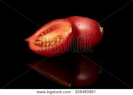 Group Of Two Halves Of Fresh Tomato De Barao Isolated On Black Glass