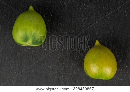Group Of Two Whole Fresh Tomato De Barao Flatlay On Grey Stone
