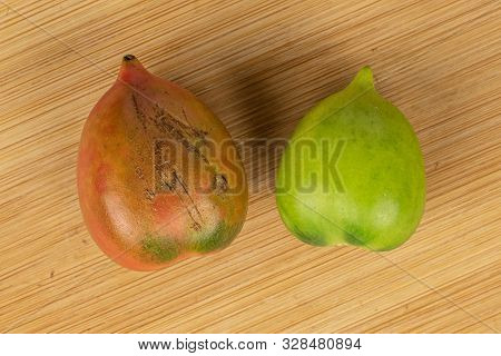 Group Of Two Whole Fresh Tomato De Barao Flatlay On Light Wood