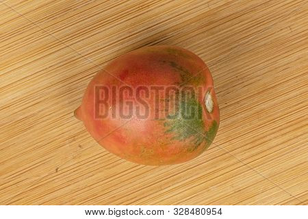 One Whole Fresh Tomato De Barao Flatlay On Light Wood