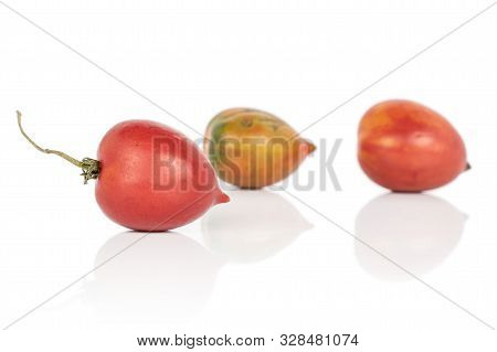 Group Of Three Whole Fresh Tomato De Barao One With Stem Isolated On White Background
