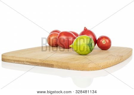 Lot Of Whole Fresh Tomato De Barao On Bamboo Cutting Board Isolated On White Background