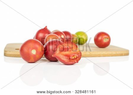 Lot Of Whole One Half Of Fresh Tomato De Barao On Bamboo Cutting Board Isolated On White Background