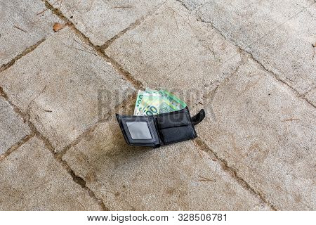 Lost Black Leather Wallet With Money Euro On Street. One Hundredth Banknotes Inside It