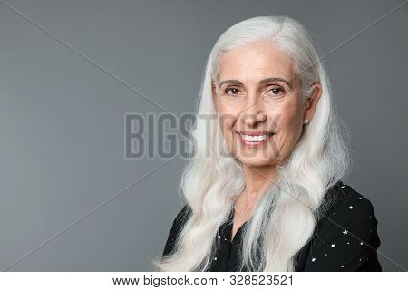 Portrait Of Beautiful Mature Woman On Grey Background, Space For Text