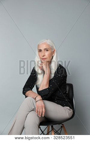 Portrait Of Beautiful Mature Woman On Grey Background