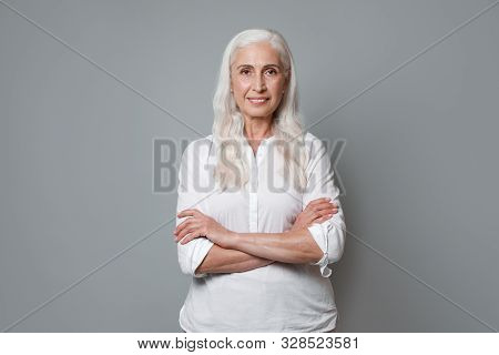 Portrait Of Beautiful Mature Woman On Grey Background
