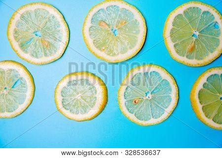 Slices Of Lemons On A Blue Background