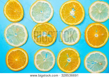 Slices Of Lemons And Oranges On A Blue Background