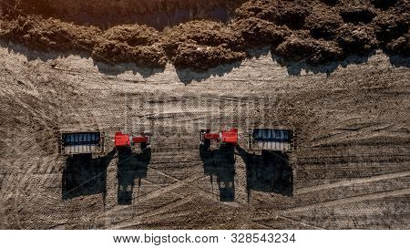 Two Tractors Near A Pile Of Organic Fertilizer Top View
