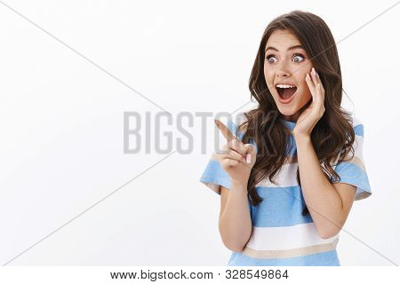 Impressed Excited Young Woman Check Out Awesome Promo, See Cool Product, Pointing Left Stare Copy Sp