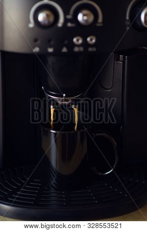Delicious Cup Of Espresso Being Poured From A Domestic Espresso Machine. Coffee Is Being Poured In A
