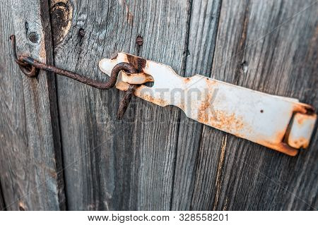 Old And Rusty Hook Locks The Old Dried Up Wooden Barn Door