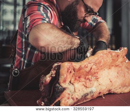 Chef cutting beef carcass in a restaurant