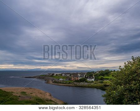 Brora / Scotland - August 28, 2019: Houses At Sunrise On The North Sea Shore In Brora