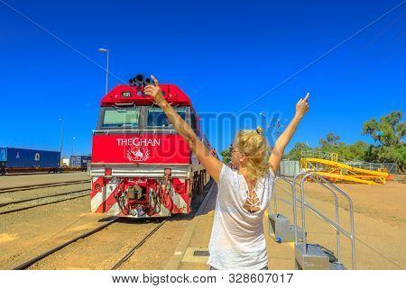 Alice Springs, Northern Territory, Australia - Aug 29, 2019: Happy Tourist Woman With Raised Arms In