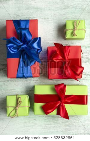 Christmas Gift Box. Christmas Presents In Colorful Boxes On A Wooden Table. View From Above. Flat La