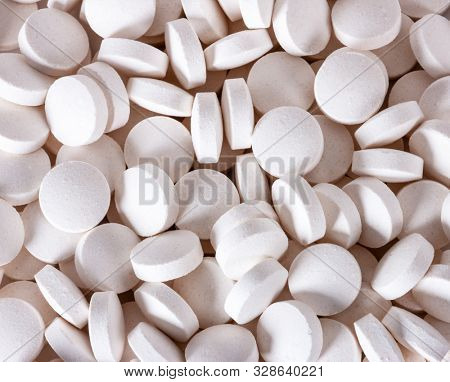 Conceptual medicine abuse, capsule and round white pills on a white background