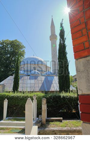 Karadoz Bey Mosque, Located On Brace Fejica Street, With Gravestones In The Foreground, Mostar, Bosn