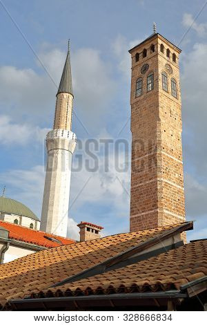 Close-up On The Minaret Of Gazi Husrev Begova Mosque And The Old Clock Tower, Located In Bascarsija 