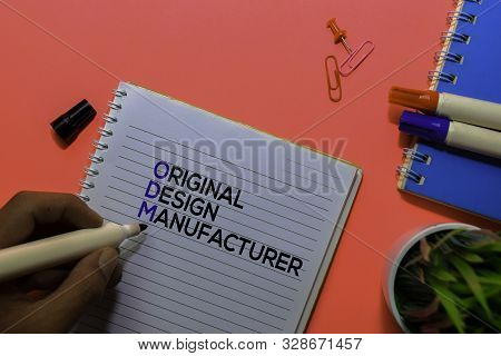 Odm. Original Design Manufacturer Acronym On Book. Office Desk Background