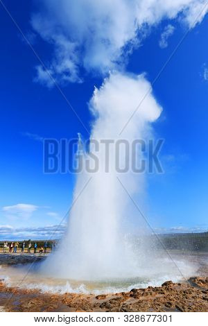 GEYSIR, ICELAND, 14 SEPTEMBER, 2019 : Erupting of the geysir. Tourists visiting the famous Geysir area in Iceland, Europe