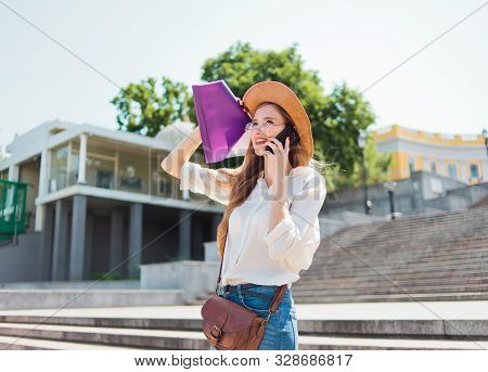 Young Caucasian Woman Student In Casual Clothing With Esse In Folder Talking On Phone Going Down The