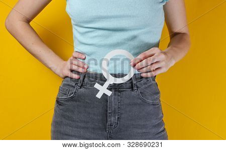Femen Concept. Woman Holds In Her Hands Gender Feminism Symbol On Yellow Background. Crop Photo, Stu