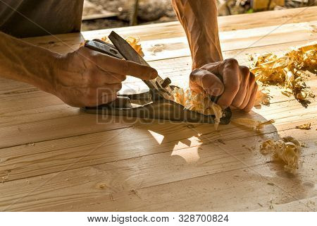 Joinery. Planing A Natural Wood Furniture Panel With A Manual Planer