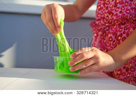 Hand Holding Homemade Toy Called Slime, Kids Having Fun And Being Creative By Science Experiment. Cl
